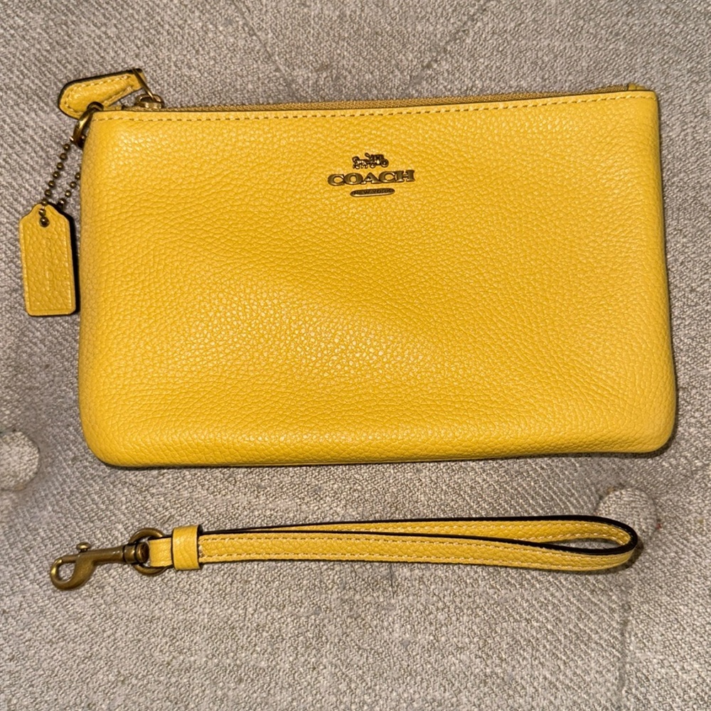 NWT, Coach pebbled leather wristlet in Sunlight .